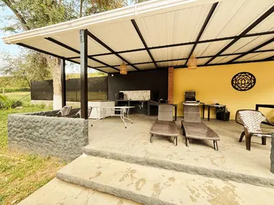 a patio with awning and chairs and a table at Villa Sol in Sopetran