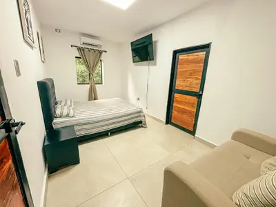 a room with a bed and a couch and a window at Villa Sol in Sopetran