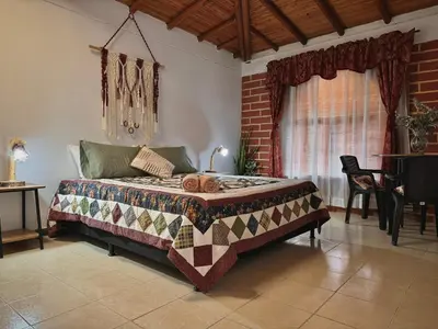 a bedroom with a bed in a room at Casa Amaru Rooms in Guarne