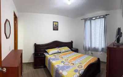 a bedroom with a bed and a dresser and a window at Apartmento 302 t1 Sol de Occidente in Sopetran
