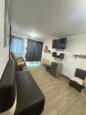 a living room with a black couch and chairs at Apartmento 302 t1 Sol de Occidente in Sopetran