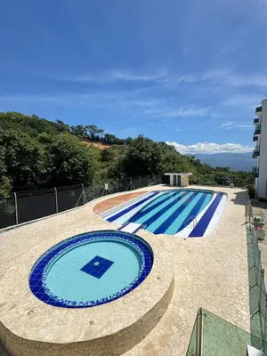 a large swimming pool sitting next to a building at Apartmento 302 t1 Sol de Occidente in Sopetran