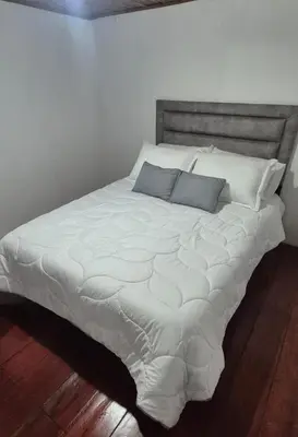 a large white bed with two pillows on it at Hospedaje en Marulanda in Marulanda