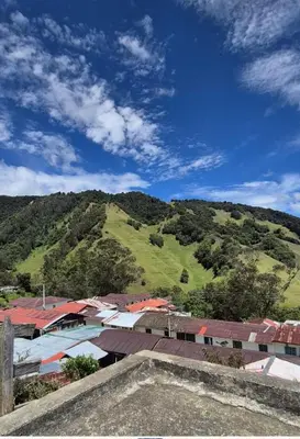 a group of buildings and a hill with trees at Hospedaje en Marulanda in Marulanda
