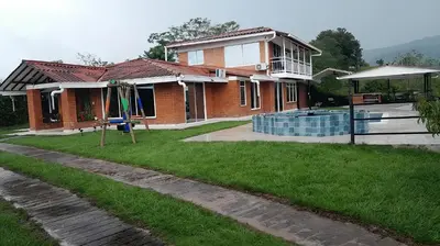 a house with a swimming pool in front of it at Colombia Escape - Cafe Acapulco Extasis in Viterbo