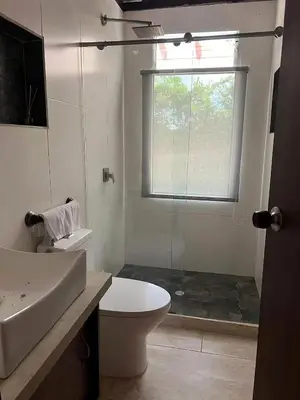 a bathroom with a toilet and a sink and a window at Colombia Escape - Cafe Acapulco Extasis in Viterbo