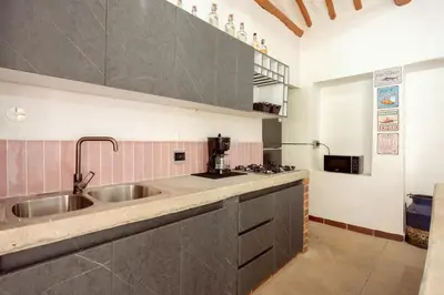 a large kitchen with a sink and a stove at Sweet Helen Casa Santa in Rionegro