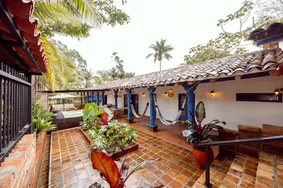 a house with a porch with a swing at Sweet Helen Casa Santa in Rionegro