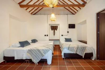 a bedroom with two beds in a room at Sweet Helen Casa Santa in Rionegro