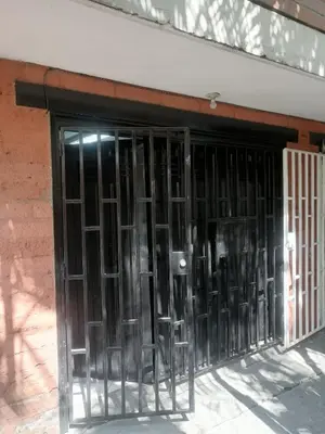 a door with black metal bars on a building at Apartaestudio en Medellín Barrio Buenos Aires in Medellín