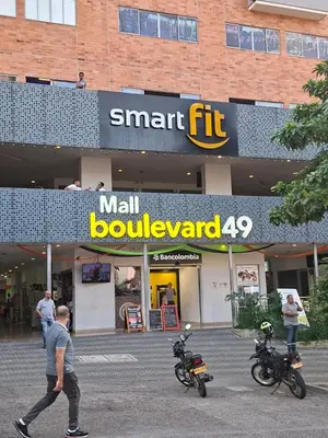 a man walking in front of a mall with two motorcycles at Apartaestudio en Medellín Barrio Buenos Aires in Medellín