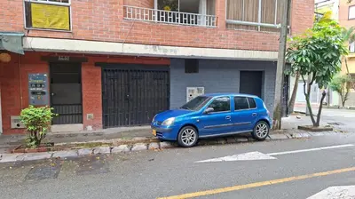a blue car parked on the side of a street at Apartaestudio en Medellín Barrio Buenos Aires in Medellín