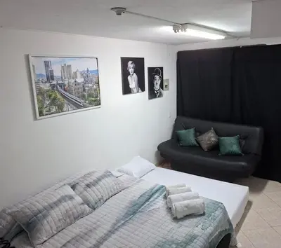 a bedroom with a bed and a couch at Apartaestudio en Medellín Barrio Buenos Aires in Medellín