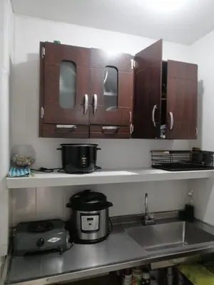 a kitchen with wooden cabinets and a sink at Apartaestudio en Medellín Barrio Buenos Aires in Medellín
