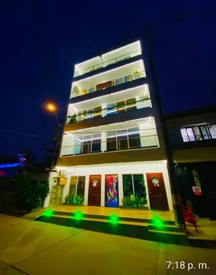 a tall building with green lights in front of it at N 303 Vacacional Doradal apta estudio in Estación El Salto