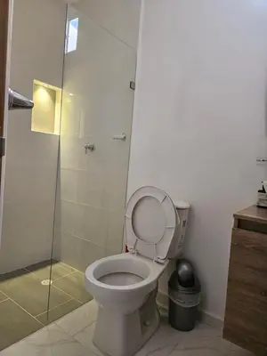 a bathroom with a toilet and a glass shower at N 303 Vacacional Doradal apta estudio in Estación El Salto