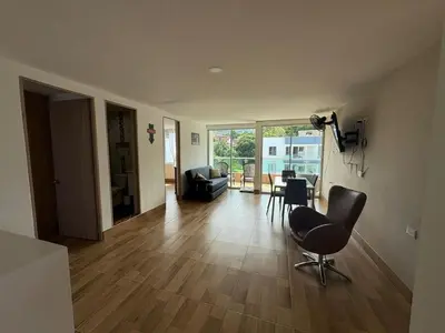 a living room with a chair and a table at Resort in Sopetrán 402 t5 sol de occidente in Sopetran