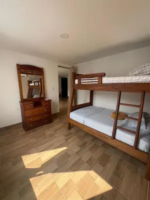 a room with two bunk beds and a mirror at Resort in Sopetrán 402 t5 sol de occidente in Sopetran