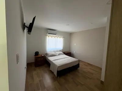 a small bedroom with a bed and a window at Resort in Sopetrán 402 t5 sol de occidente in Sopetran