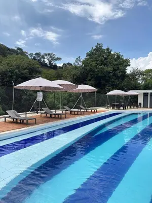 a swimming pool with umbrellas and chairs at Resort in Sopetrán 402 t5 sol de occidente in Sopetran