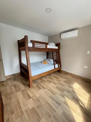 two bunk beds in a room with a wooden floor at Resort in Sopetrán 402 t5 sol de occidente in Sopetran