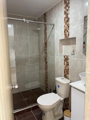 a bathroom with a toilet and a glass shower at Resort in Sopetrán 402 t5 sol de occidente in Sopetran