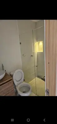 a bathroom with a toilet and a glass shower at Vacacional amoblado Doradal 302 in Doradal