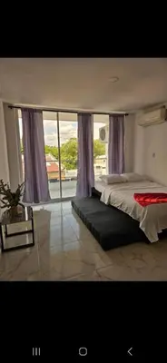 a bedroom with a bed and a large window at Vacacional amoblado Doradal 302 in Doradal