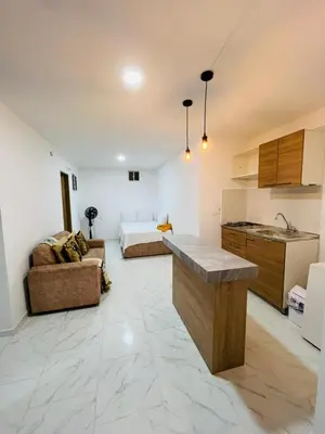 a kitchen and living room with a couch and a bed at Vacacional amoblado Doradal 302 in Doradal