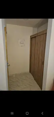 a room with a wooden door and a room with a bed at Vacacional amoblado Doradal 302 in Doradal