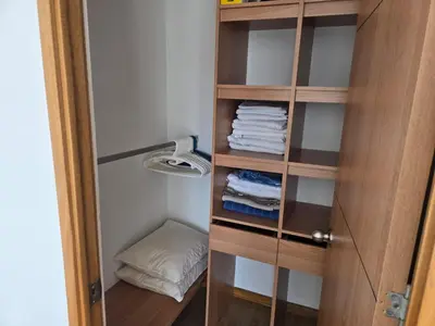 a closet with a wooden door and some towels at Amoblado Belen Avenida in Medellín