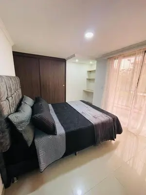 a bedroom with a bed and a large window at Acogedora casa en el carmen de Viboral in Carmen de Viboral