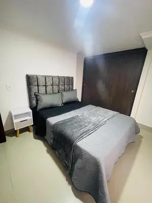 a bedroom with a large bed with a large headboard at Acogedora casa en el carmen de Viboral in Carmen de Viboral
