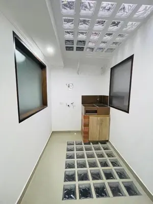 a room with a white wall with a counter and a window at Acogedora casa en el carmen de Viboral in Carmen de Viboral