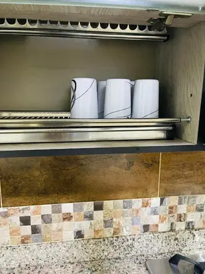 a shelf with white cups on it in a kitchen at Acogedora casa en el carmen de Viboral in Carmen de Viboral