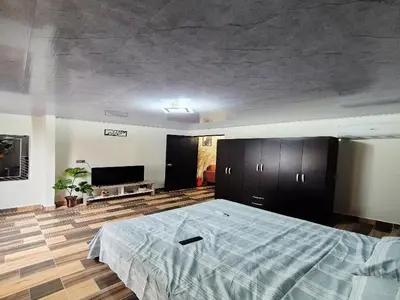 a bedroom with a large bed and a couch at Medellín urban refuge in Medellín