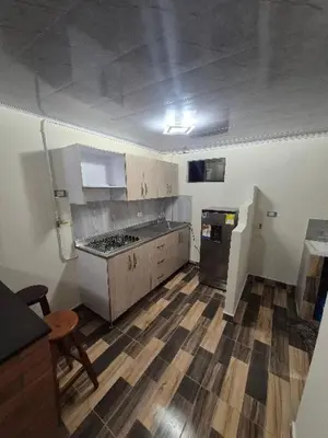an empty kitchen with a stove and a refrigerator at Medellín urban refuge in Medellín