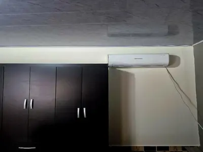 a kitchen with black cabinets and a white refrigerator at Medellín urban refuge in Medellín