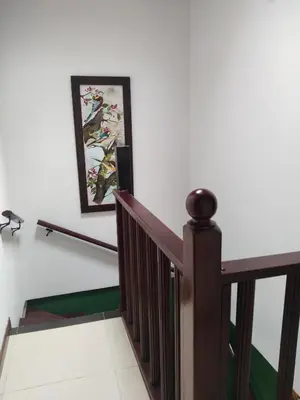 a staircase in a house with a painting on the wall at Aldea Gloria, dúplex, familiar & Pets en Laureles in Medellín