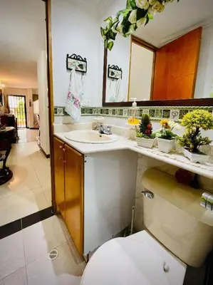 a bathroom with a toilet and a sink and a mirror at Aldea Gloria, dúplex, familiar & Pets en Laureles in Medellín