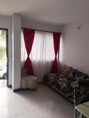 a bedroom with a bed and a window with red curtains at Aldea Gloria, dúplex, familiar & Pets en Laureles in Medellín