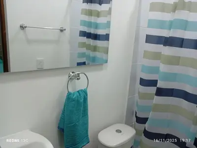 a bathroom with a toilet and a mirror at Alojamientos Jamar in Rionegro