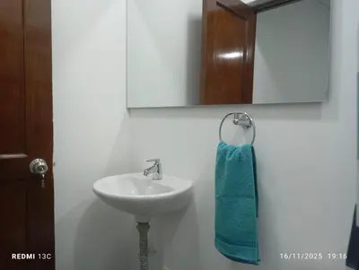 a bathroom with a sink and a blue towel at Alojamientos Jamar in Rionegro