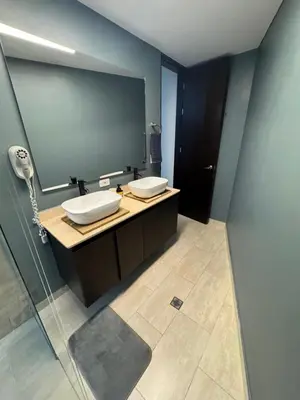 a bathroom with two sinks and a mirror at Hotel Rioverde Suite Cerca de Aeropuerto JMC in Rionegro