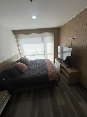 a bedroom with a large bed and a television at Hotel Rioverde Suite Cerca de Aeropuerto JMC in Rionegro