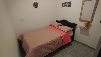 a small bedroom with a bed with a red blanket at Apartamento Rionegro, cerca de San Nicolas in Rionegro