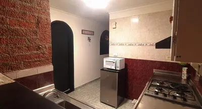 a kitchen with a stove top oven next to a brick wall at Apartamento Rionegro, cerca de San Nicolas in Rionegro