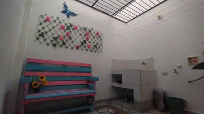 a room with a bench and a butterfly on the wall at Apartamento Rionegro, cerca de San Nicolas in Rionegro