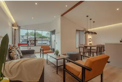 a living room with a couch and a table at El lienzo Blanco en Medellin in Envigado