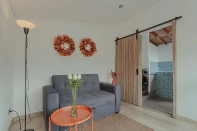 a living room with a couch and a table at El lienzo Blanco en Medellin in Envigado